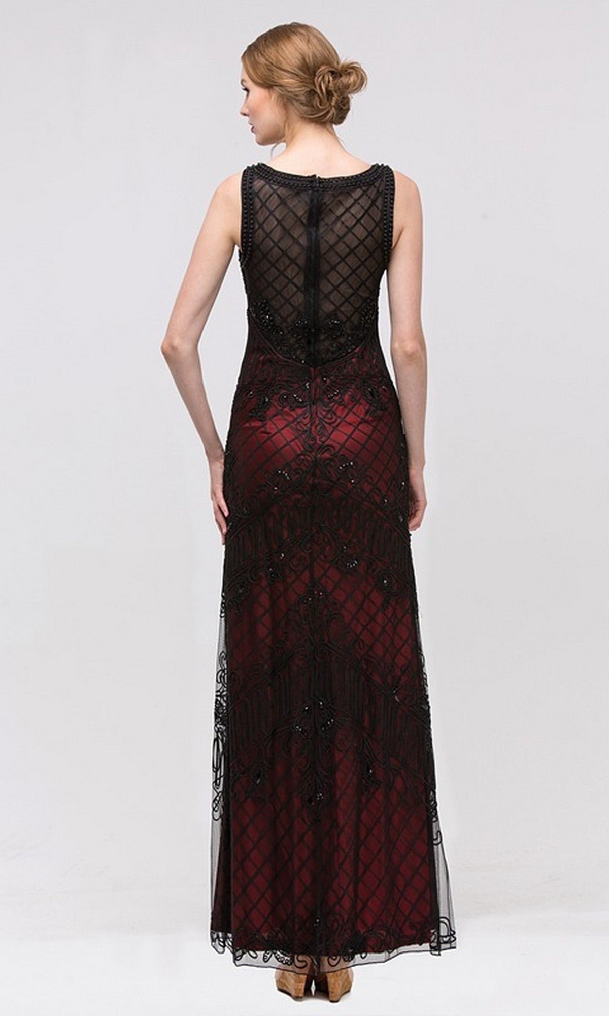 A woman stands with her back to the camera, wearing the Eureka 3915 long formal dress featuring a floor-length design with a black mesh overlay, dark red underlay, and her hair styled in a low bun.